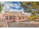 Exterior of a home with a tile roof and desert landscaping in the backyard with small firepit at 7140 Pascal Dr, Las Vegas, NV 89156