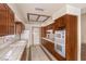 Kitchen features light tile countertops, wood cabinets, and stainless steel appliances at 7140 Pascal Dr, Las Vegas, NV 89156