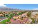 An aerial view of a well-maintained community with solar panels, lush landscaping, and mountain views at 7307 Lansbrook Ave, Las Vegas, NV 89131