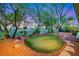 Backyard featuring a putting green, desert landscaping and scenic views at 7307 Lansbrook Ave, Las Vegas, NV 89131