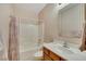 Bathroom features a shower-tub combo, vanity with sink, and tile flooring at 7307 Lansbrook Ave, Las Vegas, NV 89131