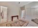 Bedroom features carpet, neutral walls, ceiling fan, closet and entry to the bathroom at 7307 Lansbrook Ave, Las Vegas, NV 89131