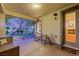 Covered patio with comfortable seating and view of landscaped backyard at 7307 Lansbrook Ave, Las Vegas, NV 89131