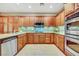 Bright kitchen features hardwood floors, stainless appliances, and a tile backsplash at 7307 Lansbrook Ave, Las Vegas, NV 89131
