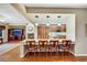 Open-concept kitchen and living area with a large island and fireplace at 7307 Lansbrook Ave, Las Vegas, NV 89131