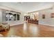 Open-concept living room with hardwood floors and bar seating to the kitchen and backyard views at 7307 Lansbrook Ave, Las Vegas, NV 89131