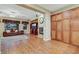 Open-concept living room with hardwood floors, built-in storage, and a cozy fireplace at 7307 Lansbrook Ave, Las Vegas, NV 89131