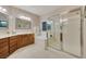 Bright main bathroom with dual vanities, soaking tub, and glass-enclosed shower at 7307 Lansbrook Ave, Las Vegas, NV 89131