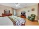 Relaxing main bedroom with hardwood floors, neutral decor, and comfortable furnishings at 7307 Lansbrook Ave, Las Vegas, NV 89131