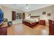 Spacious main bedroom with natural light, hardwood floors, and classic furniture at 7307 Lansbrook Ave, Las Vegas, NV 89131