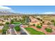 An aerial view of the neighborhood featuring mature landscaping and a mountain backdrop at 7307 Lansbrook Ave, Las Vegas, NV 89131