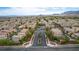 Expansive aerial view showcases a well-planned community with uniform homes and picturesque mountain backdrop at 7559 Chimney Point Ct, Las Vegas, NV 89166
