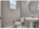 Powder room features a pedestal sink, toilet, and modern design for a functional space at 7559 Chimney Point Ct, Las Vegas, NV 89166
