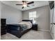 Stylish bedroom includes a ceiling fan, a window with blinds, and a sleek dark-toned furniture set at 7559 Chimney Point Ct, Las Vegas, NV 89166