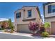 Two-story home featuring a two-car garage, neutral stucco, and low-maintenance landscaping at 7559 Chimney Point Ct, Las Vegas, NV 89166