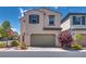 Two-story home featuring a two-car garage, neutral stucco, and low-maintenance landscaping at 7559 Chimney Point Ct, Las Vegas, NV 89166