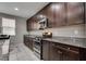 Modern kitchen featuring granite countertops, stainless steel appliances, and dark cabinetry at 7559 Chimney Point Ct, Las Vegas, NV 89166