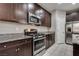 Modern kitchen featuring granite countertops, stainless steel appliances, and dark cabinetry at 7559 Chimney Point Ct, Las Vegas, NV 89166