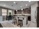 Modern kitchen with granite countertops, island with breakfast bar, and stainless steel appliances at 7559 Chimney Point Ct, Las Vegas, NV 89166