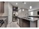 Modern kitchen featuring granite countertops, stainless steel appliances, and dark cabinetry at 7559 Chimney Point Ct, Las Vegas, NV 89166