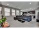 Spacious living room with neutral walls and carpeting, large sectional, and plenty of natural light at 7559 Chimney Point Ct, Las Vegas, NV 89166