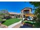 Well-manicured backyard featuring artificial turf, a patio, and a charming pergola, perfect for outdoor entertaining at 7609 Rory Ct, Las Vegas, NV 89129