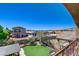 Spacious backyard with a well-manicured lawn, desert landscaping, and a cozy patio area at 7609 Rory Ct, Las Vegas, NV 89129