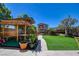 Landscaped backyard with custom pergola, perfect for outdoor gatherings and relaxation in a serene setting at 7609 Rory Ct, Las Vegas, NV 89129