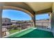 Large covered balcony with artificial turf overlooking neighborhood and mountain views at 7609 Rory Ct, Las Vegas, NV 89129