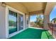 Spacious covered balcony featuring artificial turf and a wrought iron railing at 7609 Rory Ct, Las Vegas, NV 89129