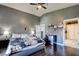 Bright bedroom showcasing vaulted ceilings, dark wood floors, and an ensuite bathroom at 7609 Rory Ct, Las Vegas, NV 89129