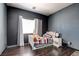 Charming bedroom featuring dark walls, a comfortable twin bed, and soft natural lighting at 7609 Rory Ct, Las Vegas, NV 89129