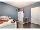 Comfortable bedroom with wood floors, a twin bed, and light blue walls, creating a tranquil space at 7609 Rory Ct, Las Vegas, NV 89129