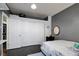 Bedroom with gray walls, a large closet, and a comfortable bed, offering ample storage and relaxation at 7609 Rory Ct, Las Vegas, NV 89129