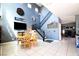 Dining room area with tile floors, high ceilings, and an adjacent staircase leading upstairs at 7609 Rory Ct, Las Vegas, NV 89129