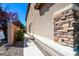 Close up of the stucco and stone accent wall along the side of the home and walkway at 7609 Rory Ct, Las Vegas, NV 89129