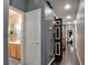 Hallway with wood flooring, multiple doors, and neutral wall colors leading to different rooms at 7609 Rory Ct, Las Vegas, NV 89129