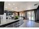 Bright kitchen with granite countertops, updated appliances, and a bar area overlooking the backyard at 7609 Rory Ct, Las Vegas, NV 89129