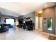Open-concept living area with tile floors, neutral walls, and a built in entertainment center at 7609 Rory Ct, Las Vegas, NV 89129