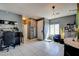 Open-concept living room with tile floors, modern lighting, and an adjacent dining area at 7609 Rory Ct, Las Vegas, NV 89129