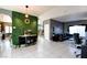 Open-concept living space featuring tile floors, neutral decor, and seamless flow to dining at 7609 Rory Ct, Las Vegas, NV 89129