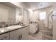 Well-lit bathroom with double sinks, granite counters, and tile flooring at 7721 Sheliak St, North Las Vegas, NV 89084