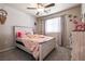 Bedroom with ceiling fan, natural light, and wooden dresser at 7721 Sheliak St, North Las Vegas, NV 89084