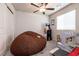Carpeted bedroom featuring ceiling fan, and gaming area with arcade at 7721 Sheliak St, North Las Vegas, NV 89084