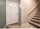 Home entryway featuring a white front door with glass panes and a view of the staircase leading to the upper level at 7721 Sheliak St, North Las Vegas, NV 89084