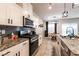 Bright kitchen featuring granite counters, stainless appliances, and modern lighting at 7721 Sheliak St, North Las Vegas, NV 89084