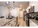 Modern kitchen featuring granite counters, stainless appliances, and pendant lighting at 7721 Sheliak St, North Las Vegas, NV 89084