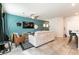 Bright living space featuring tile floors, modern furniture, a large television, and open layout to the kitchen and dining area at 7721 Sheliak St, North Las Vegas, NV 89084
