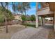 Spacious backyard with a paver patio, artificial turf, and a covered outdoor living area at 7878 Brianna Cheerful Ave, Las Vegas, NV 89178