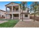 Charming two-story home with a balcony, covered patio, and lush backyard with artificial turf at 7878 Brianna Cheerful Ave, Las Vegas, NV 89178